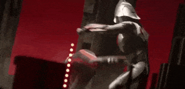 a black and white image of a superhero fighting another superhero .
