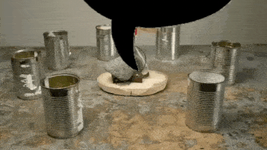 a group of tin cans are sitting on a table with a speech bubble above them