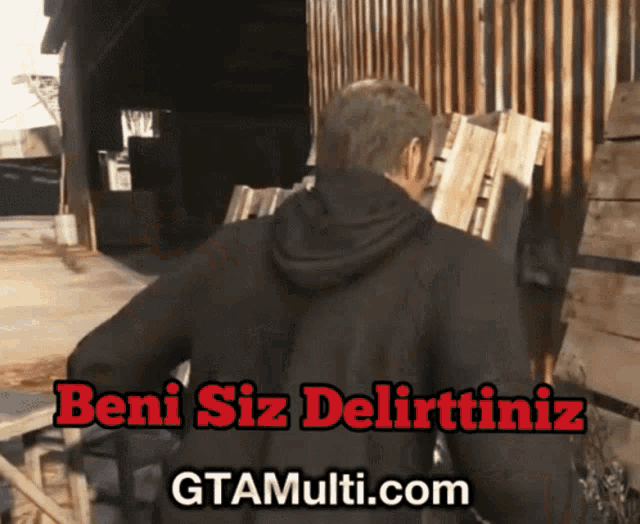 a man in a black jacket is standing in front of a wooden fence with the words beni siz delirttiniz on the bottom