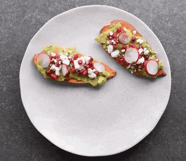 two slices of toast with guacamole and radishes on a plate