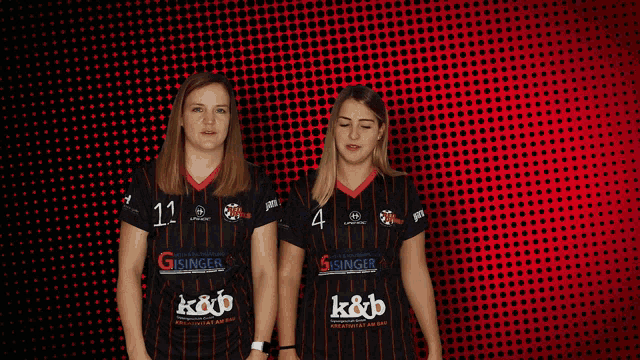 two women wearing black striped shirts with gsinger on the front