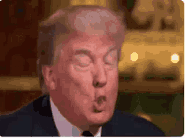a close up of donald trump making a funny face .