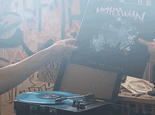 a person is holding up a record that says the meth lab on it