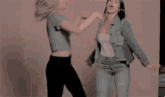 two women are standing next to each other and dancing .