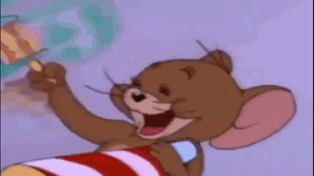 a close up of a cartoon mouse holding a toothbrush and smiling .