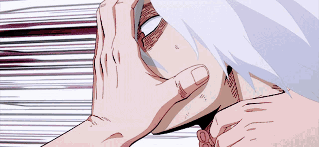 a close up of a person 's face with a hand covering it