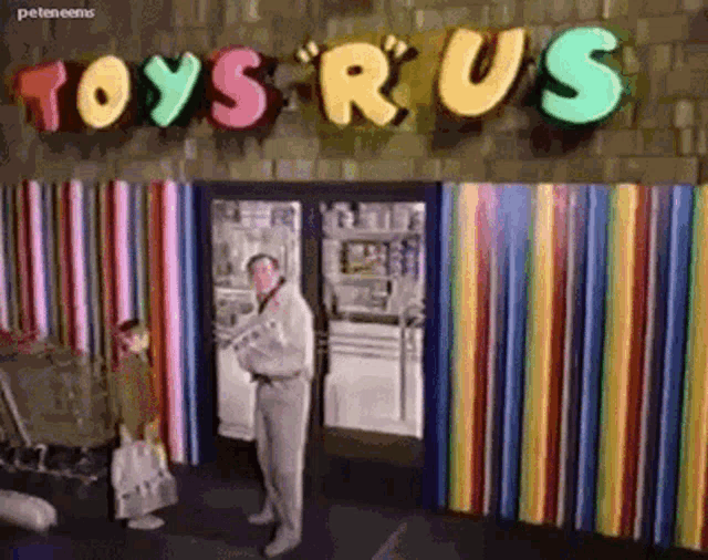 a man is standing outside of a toys r us store