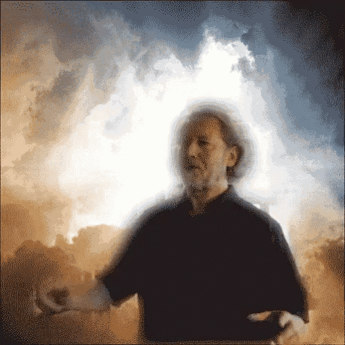 a blurry picture of a man standing in front of a cloudy sky