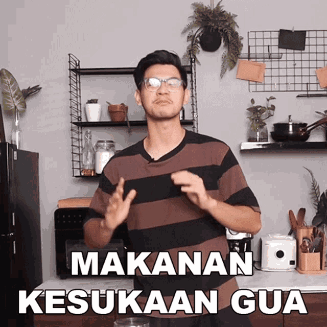 a man in a kitchen with the words makanan kesukaan gua