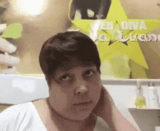 a woman with short hair is making a funny face in front of a sign that says web dna