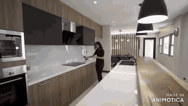a woman standing in a kitchen with the words made in animotica on the bottom right