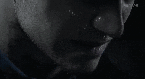 a close up of a man 's face with konami written on the bottom