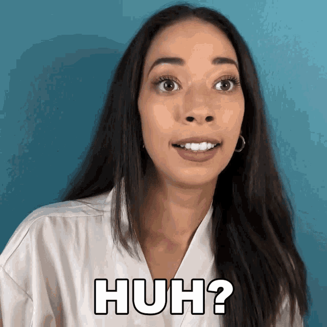 a woman in a white shirt is making a funny face and says huh