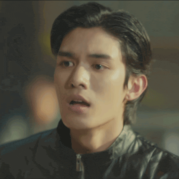 a young man in a black leather jacket is making a surprised face