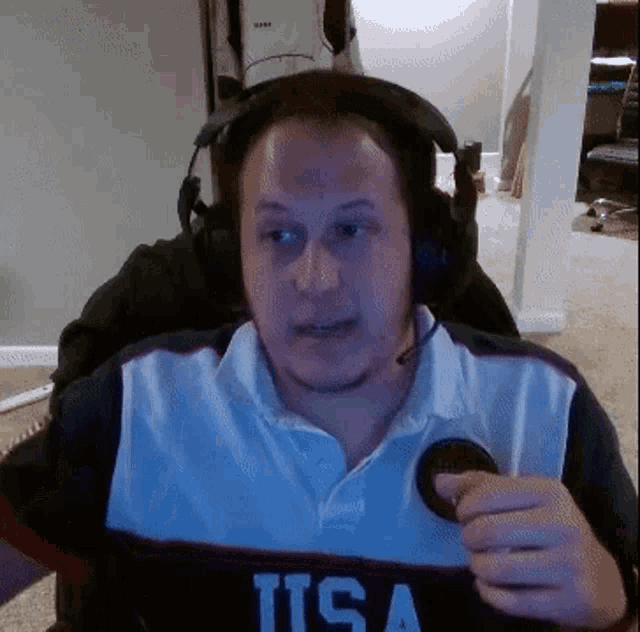 a man wearing headphones and a shirt with the word usa on it