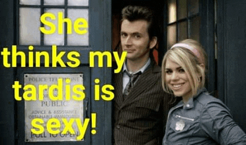a man and a woman are standing in front of a police box and smiling .