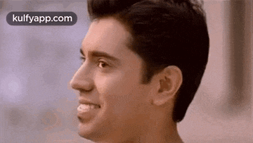 a close up of a man 's face with a smile on it .