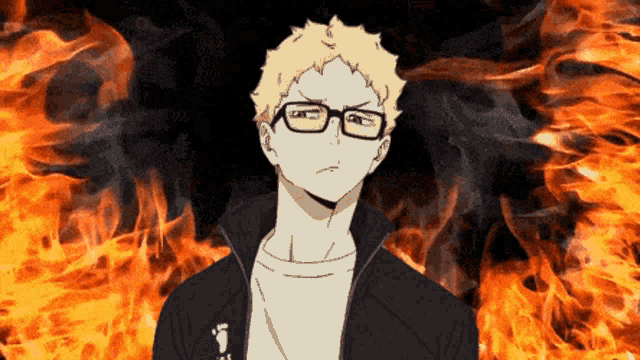 a man wearing glasses stands in front of a fire