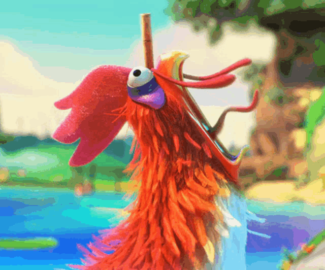 a colorful rooster with a straw in its mouth