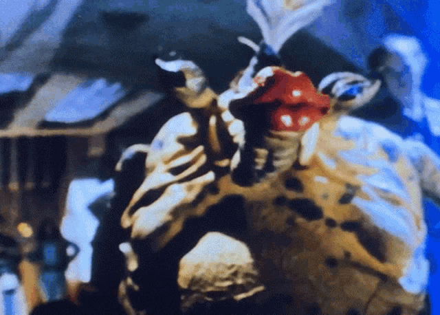a close up of a person holding a red object in their mouth