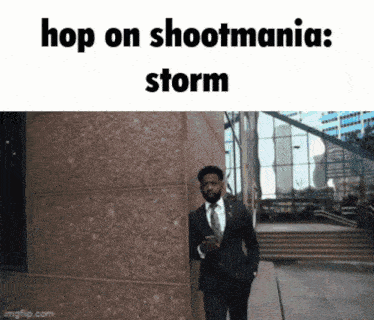 a man in a suit and tie walking in front of a building with the words hop on shootmania storm below him