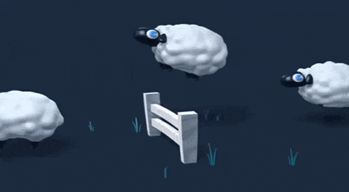 a group of sheep jumping over a fence in the dark