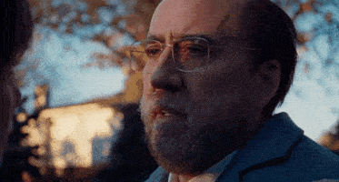 a man with glasses and a beard is talking to someone