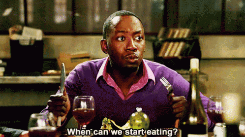 a man is sitting at a table holding a knife and fork and asking when can we start eating