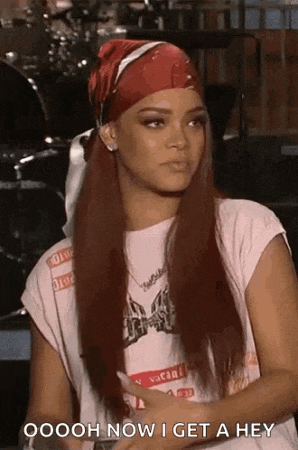 a woman wearing a bandana and a t-shirt is sitting down and talking to someone .