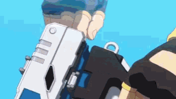 a person is holding a gun in their hand .