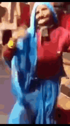 a blurry picture of a person wearing a blue hoodie