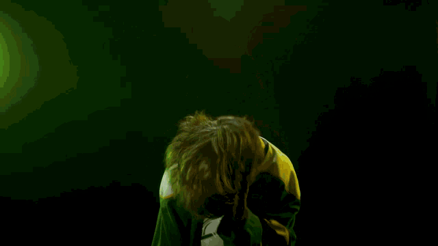 a young man wearing a green and yellow hockey jersey with the word ohl on the front