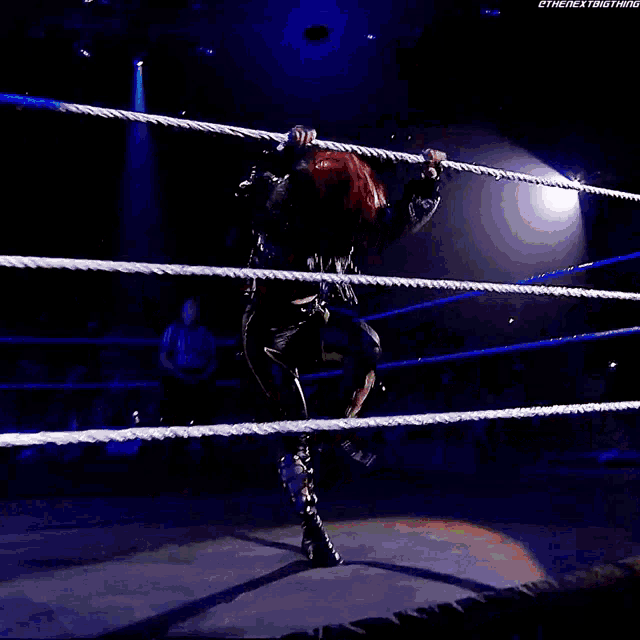 a woman with red hair is in a wrestling ring with the next thing written on the bottom