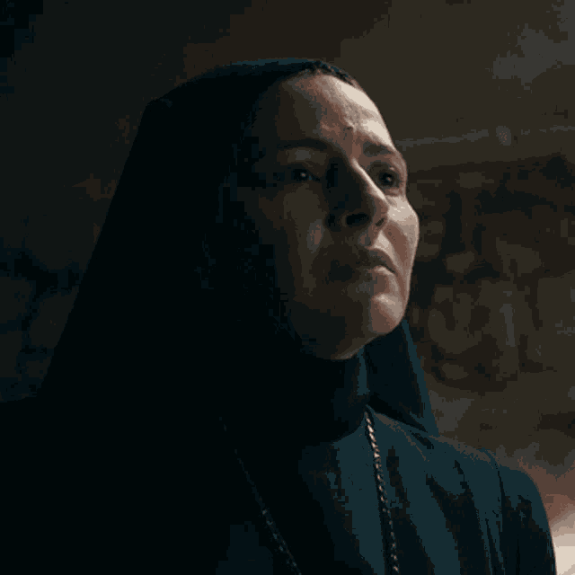 a nun says " i 'm sorry " in white letters