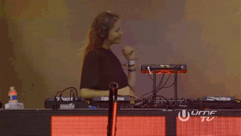 a woman is playing music at a dj booth that says uhf tv