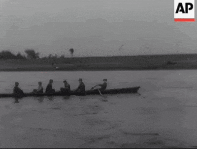 a black and white photo of a group of people in a boat with the letters ap on the bottom right