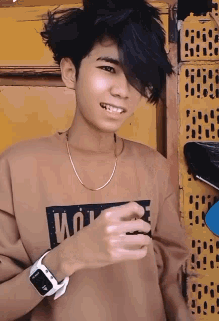 a young man wearing a sweatshirt that says " wolf " on it