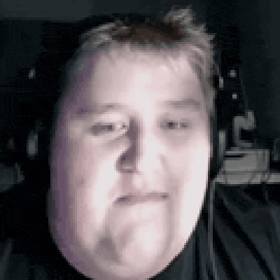 a man with headphones on is making a funny face .