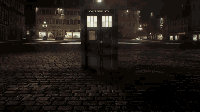 a police public box is lit up in a dark street