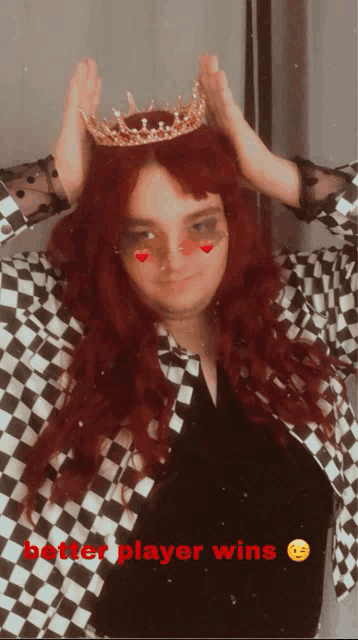 a woman with red hair wearing a crown and a checkered jacket