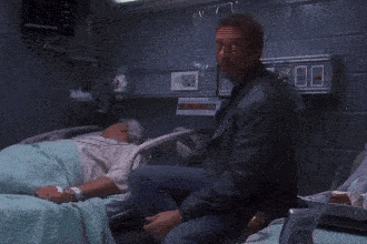 a blurry picture of a man looking at something in a room