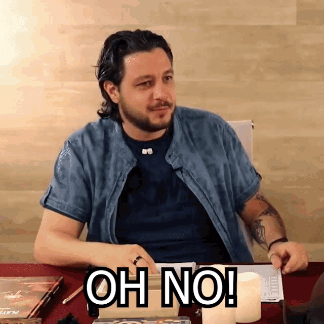 a man sitting at a table with the words oh no on the table