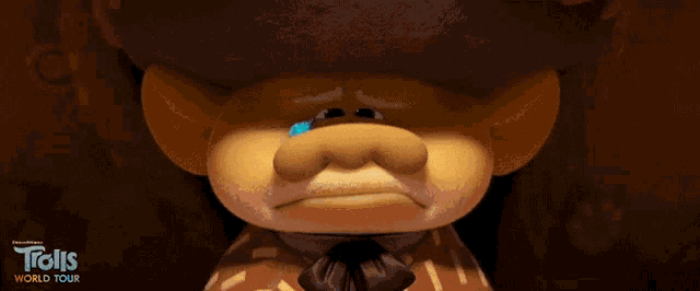 a troll from trolls world tour is crying with a blue tear on his nose