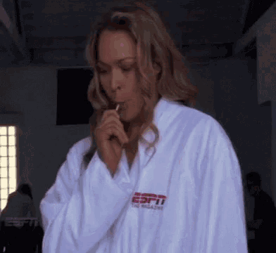 a woman in a white robe with the word espn on the front