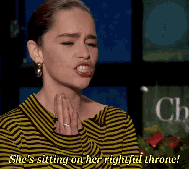 a woman in a yellow and black striped shirt is sitting on her rightful throne
