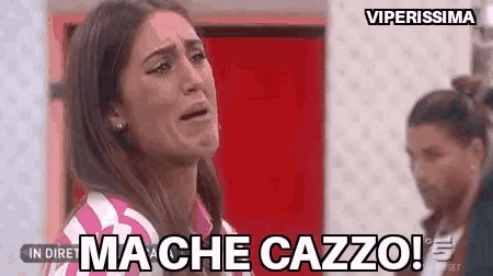 a woman is crying in front of a red door and a woman is standing behind her .