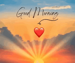 the sun is shining through the clouds and there is a red heart hanging from it .