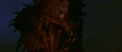 a large explosion in the dark with a dragon flying in the background