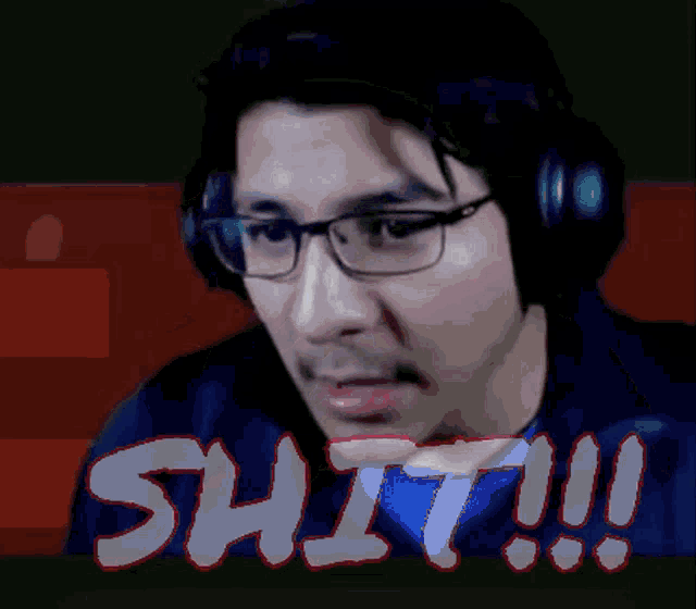 a man wearing glasses and headphones says shit !!!