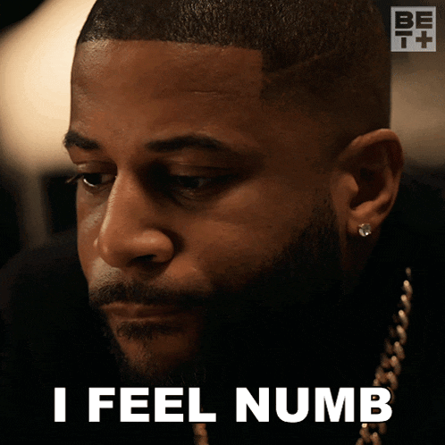 a man with a beard says i feel numb in front of his face